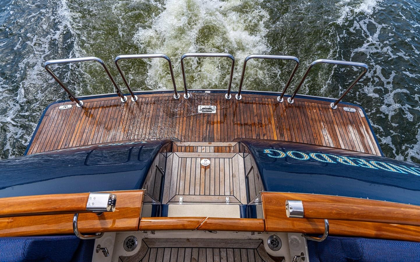 a large boat with a metal railing aboard UNDERDOG Yacht for Sale