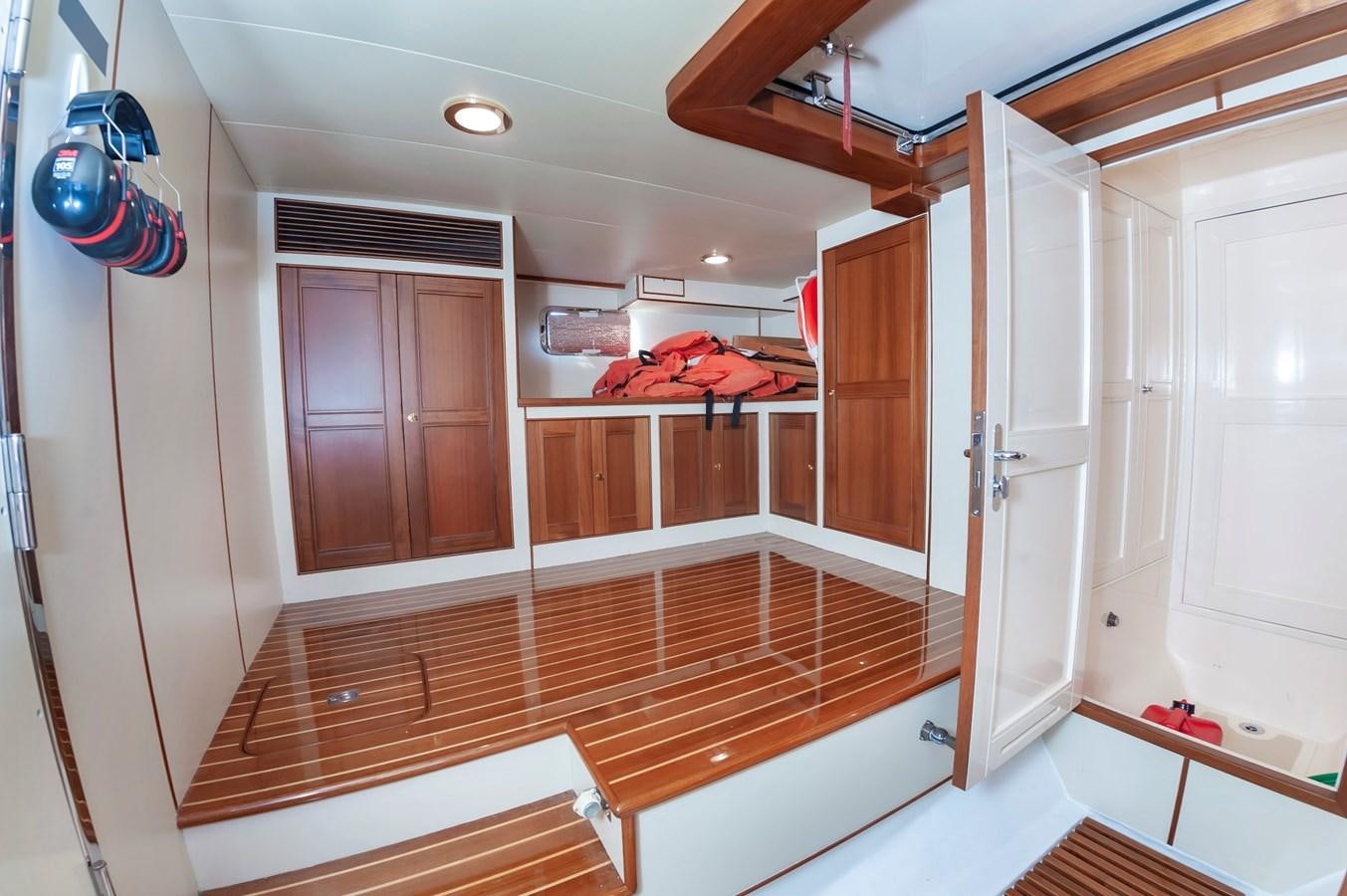 a room with wooden cabinets aboard UNDERDOG Yacht for Sale