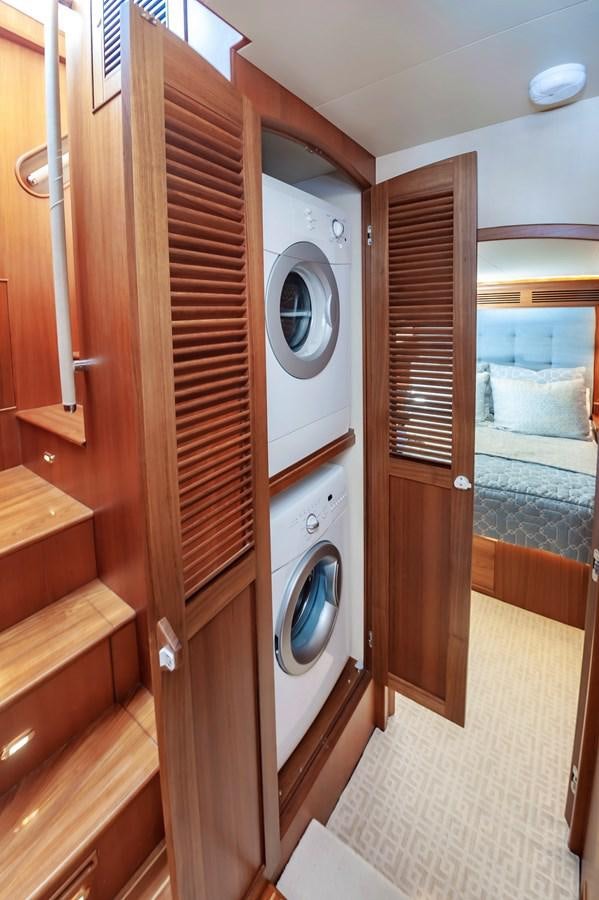 a room with a washing machine and a door aboard UNDERDOG Yacht for Sale