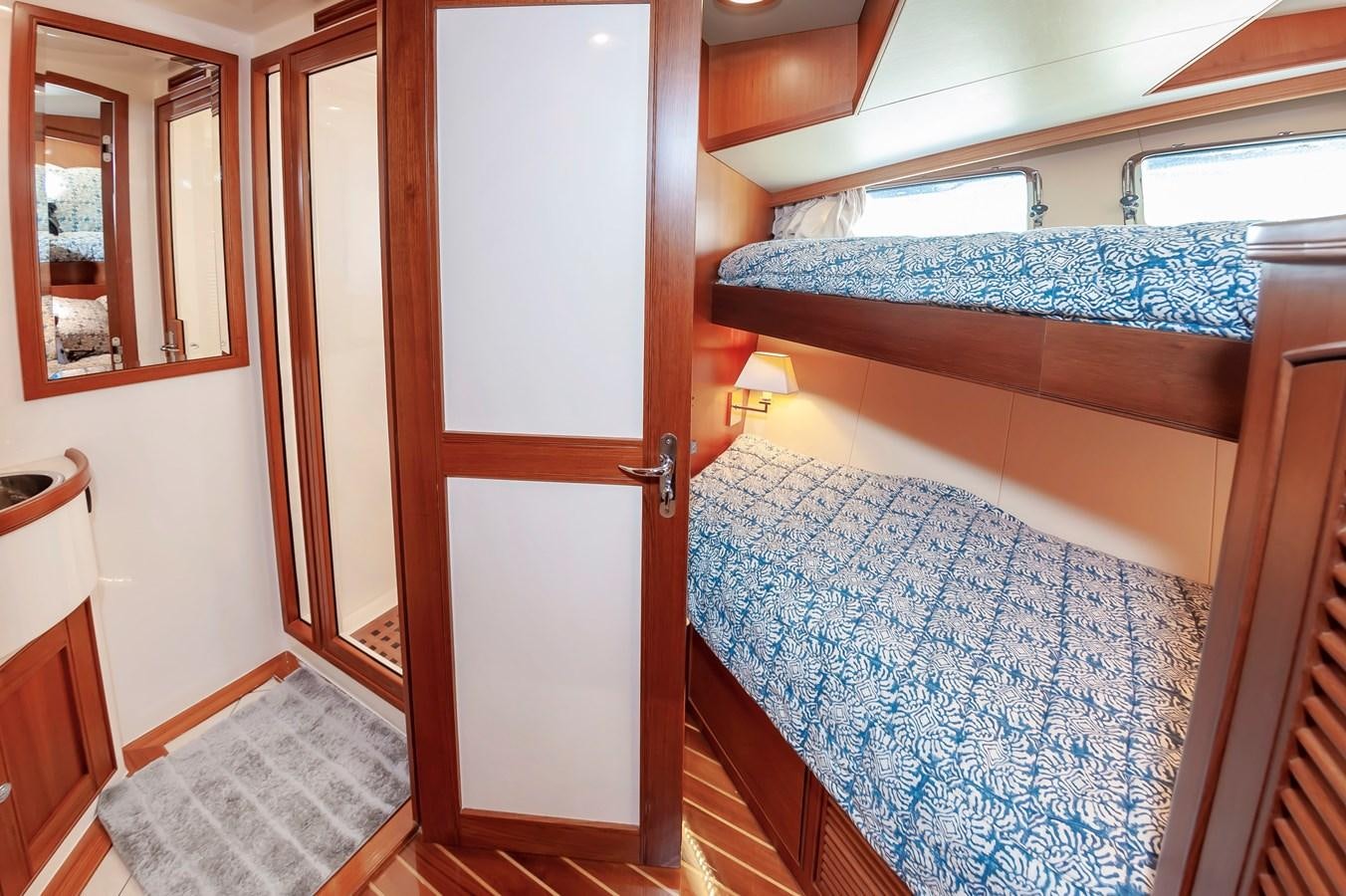 a bedroom with a bed and a door aboard UNDERDOG Yacht for Sale