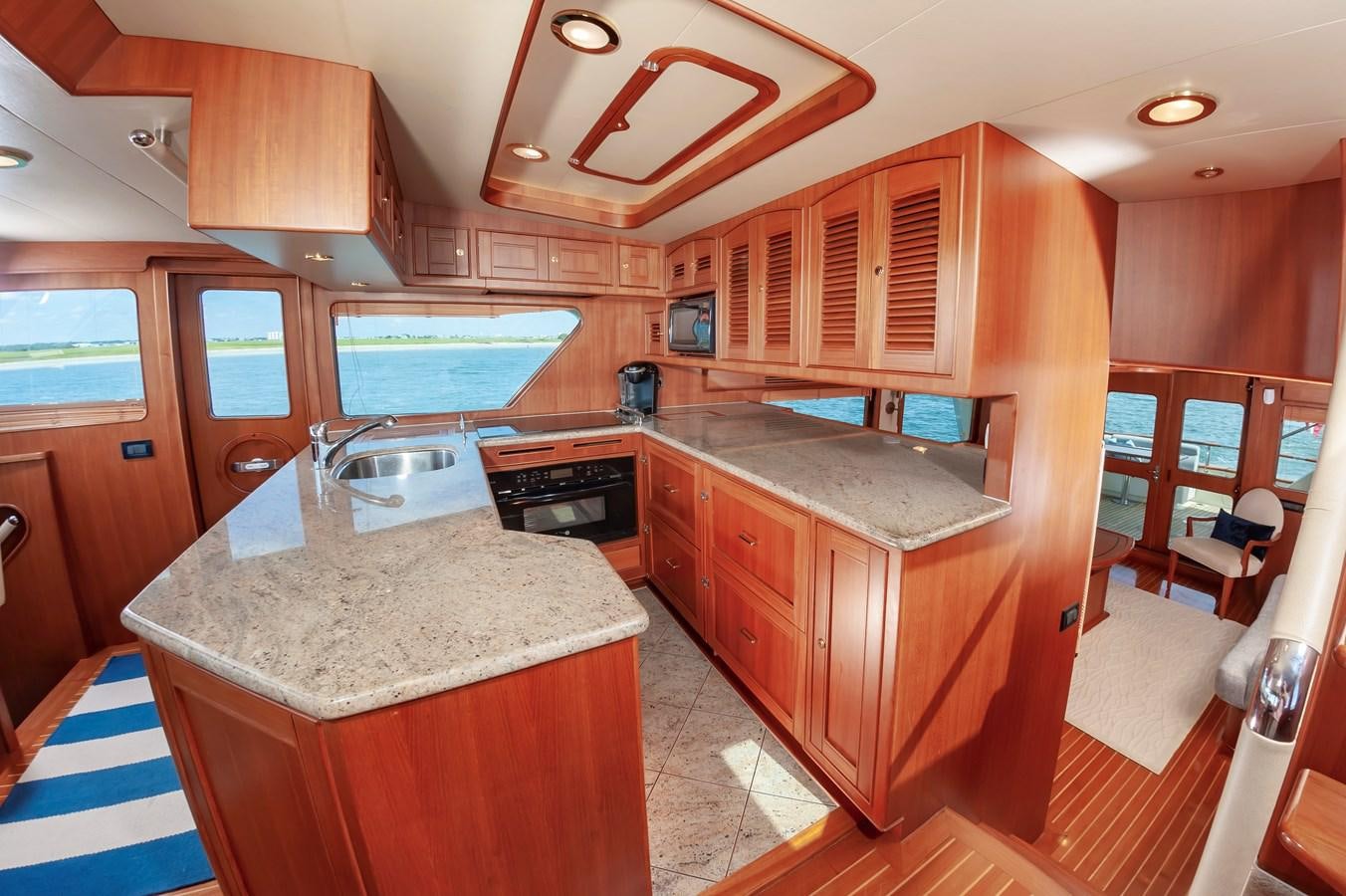 a kitchen with wooden cabinets aboard UNDERDOG Yacht for Sale