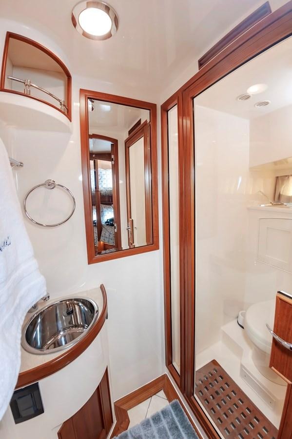 a bathroom with a sink and mirror aboard UNDERDOG Yacht for Sale