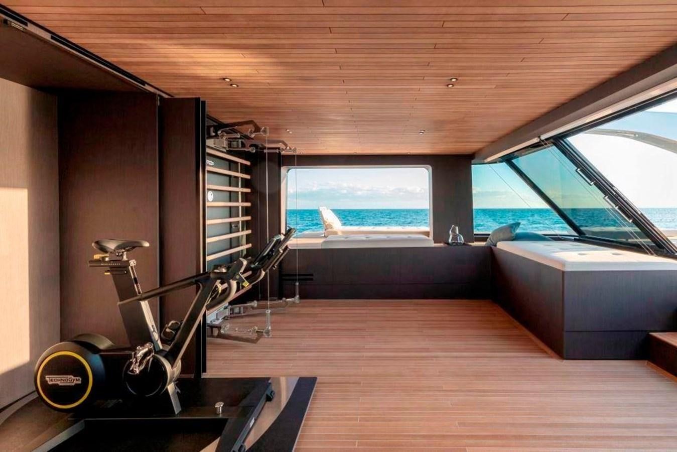 a room with a large window and a bench aboard HM 1 Yacht for Sale