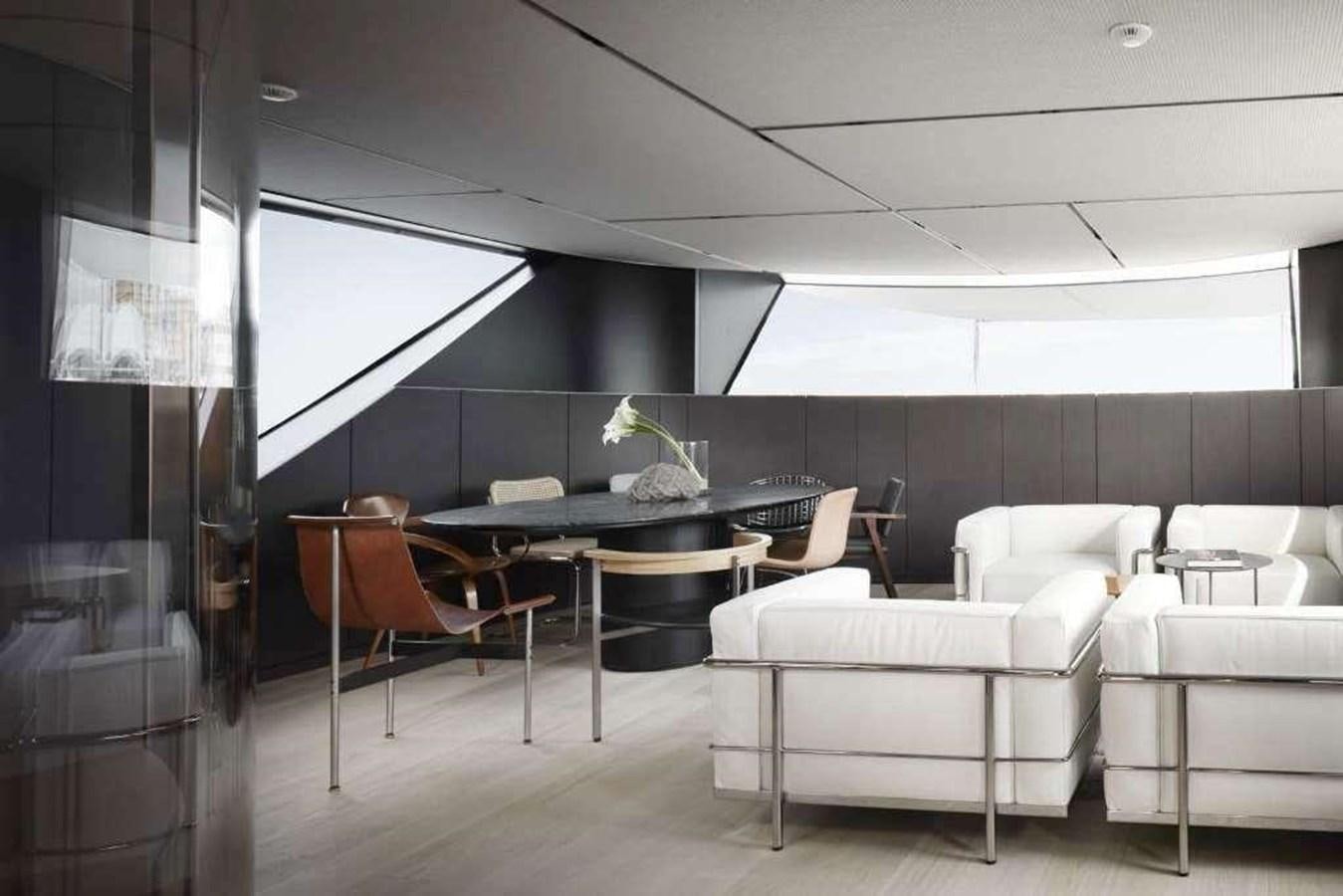 a room with a table and chairs aboard HM 1 Yacht for Sale