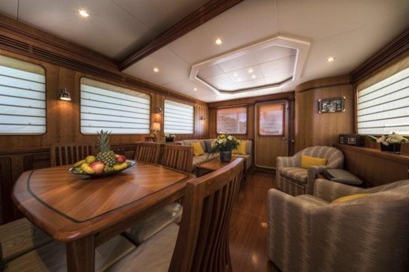 a living room with a table and couches aboard 2024 SELENE 62 Yacht for Sale