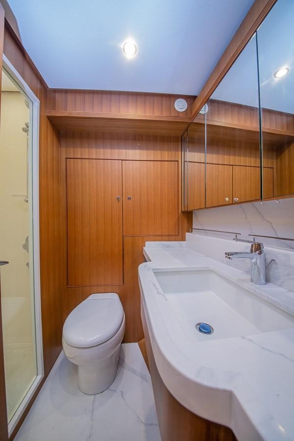 a bathroom with a toilet sink and a mirror aboard 2024 SELENE 62 Yacht for Sale