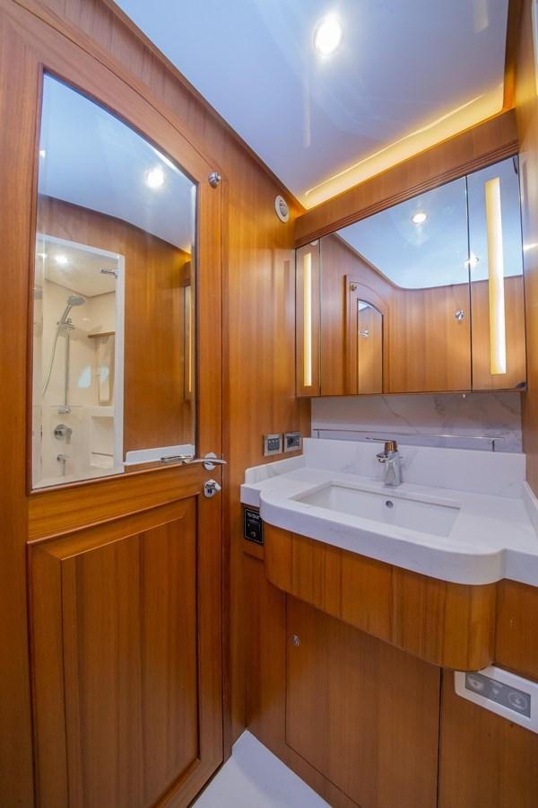 a bathroom with wooden cabinets aboard 2024 SELENE 62 Yacht for Sale
