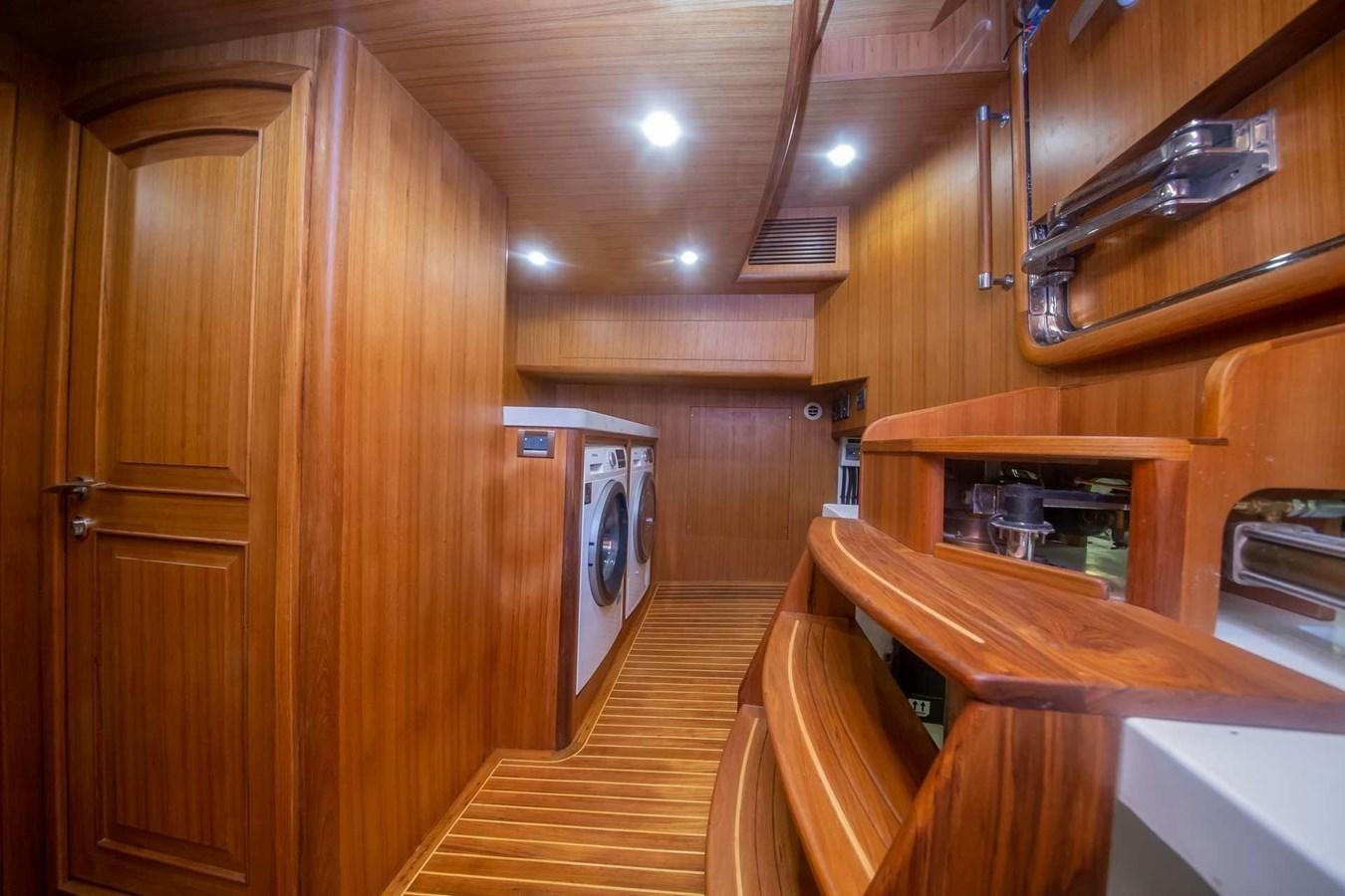 a kitchen with wooden cabinets aboard 2024 SELENE 62 Yacht for Sale