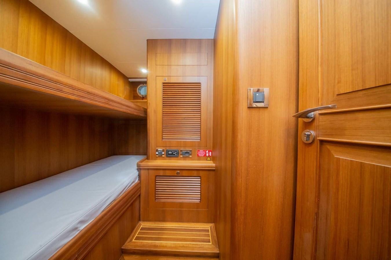 a wooden room with a bed and a door aboard 2024 SELENE 62 Yacht for Sale