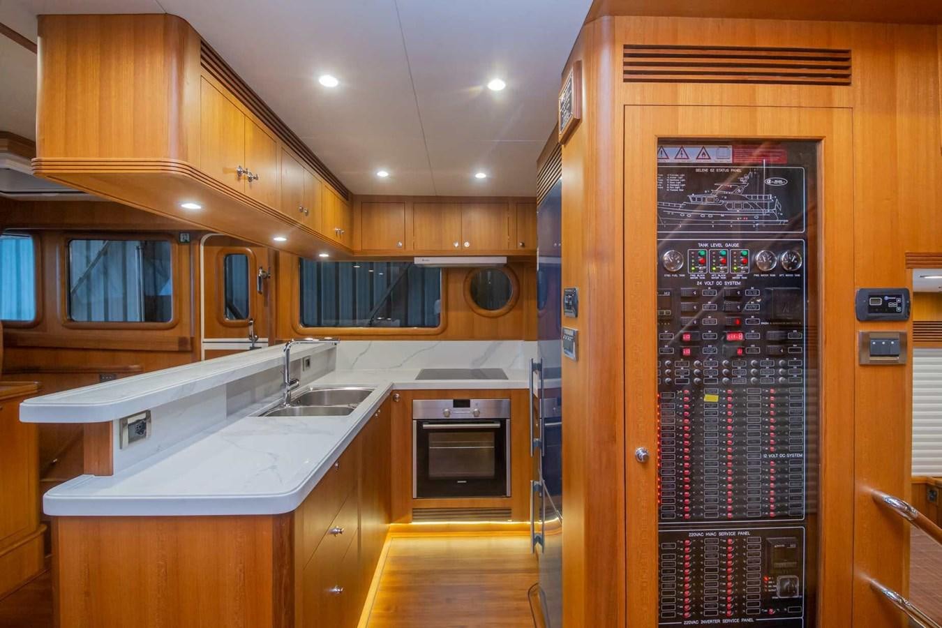 a kitchen with wooden cabinets aboard 2024 SELENE 62 Yacht for Sale