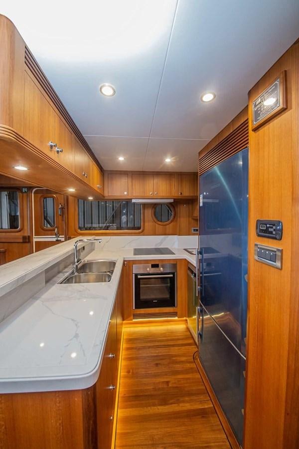 a kitchen with wooden cabinets aboard 2024 SELENE 62 Yacht for Sale