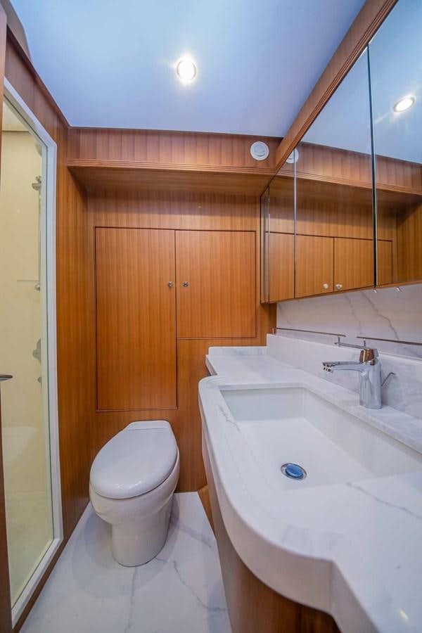 a bathroom with a toilet sink and a mirror aboard 2024 SELENE 62 Yacht for Sale