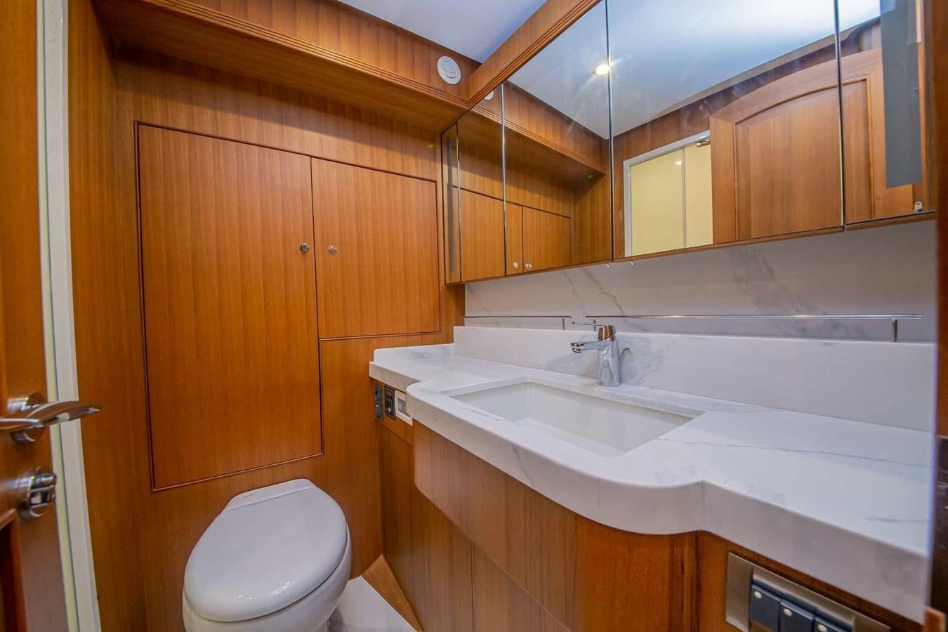 a bathroom with wooden cabinets aboard 2024 SELENE 62 Yacht for Sale