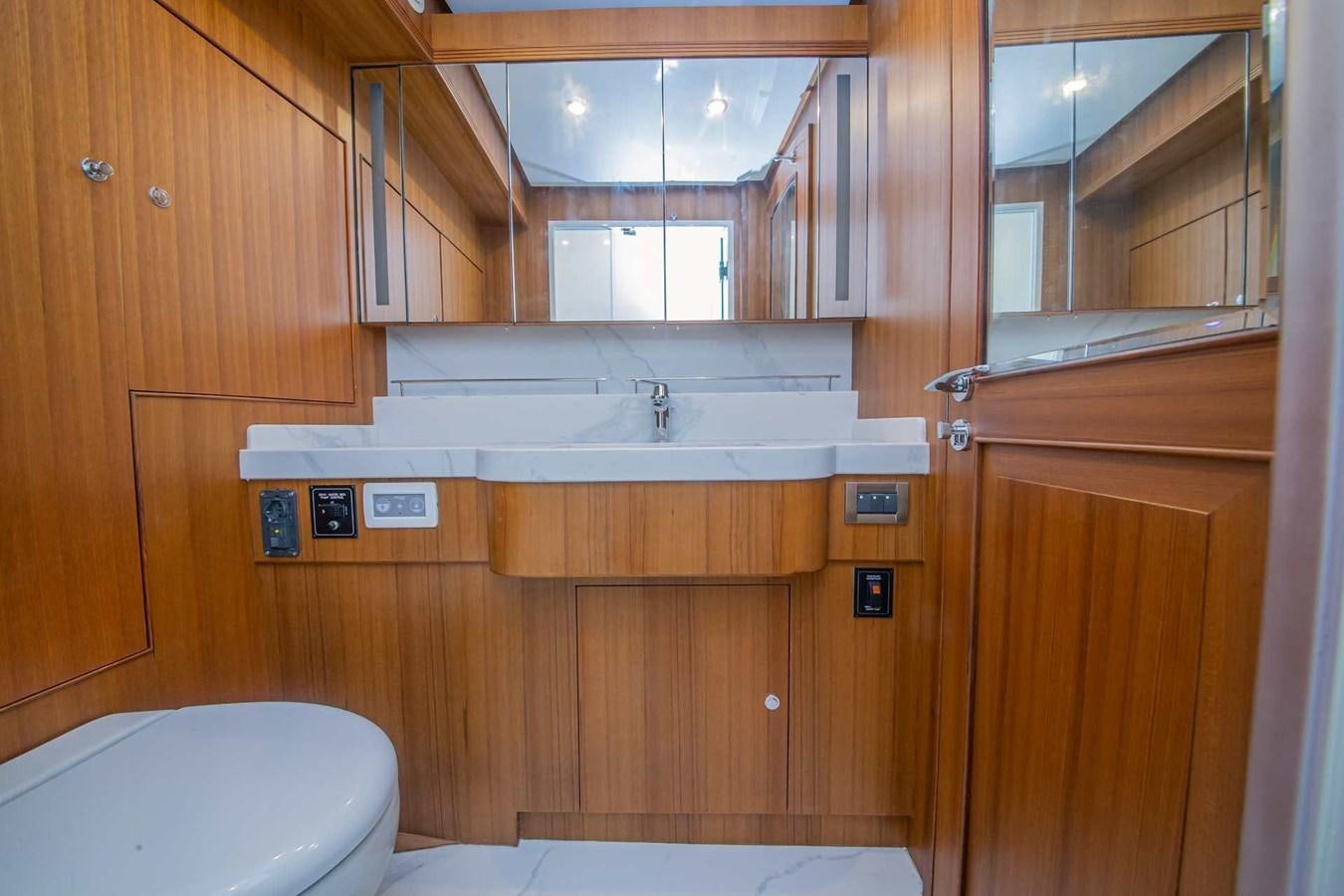 a bathroom with wooden cabinets aboard 2024 SELENE 62 Yacht for Sale