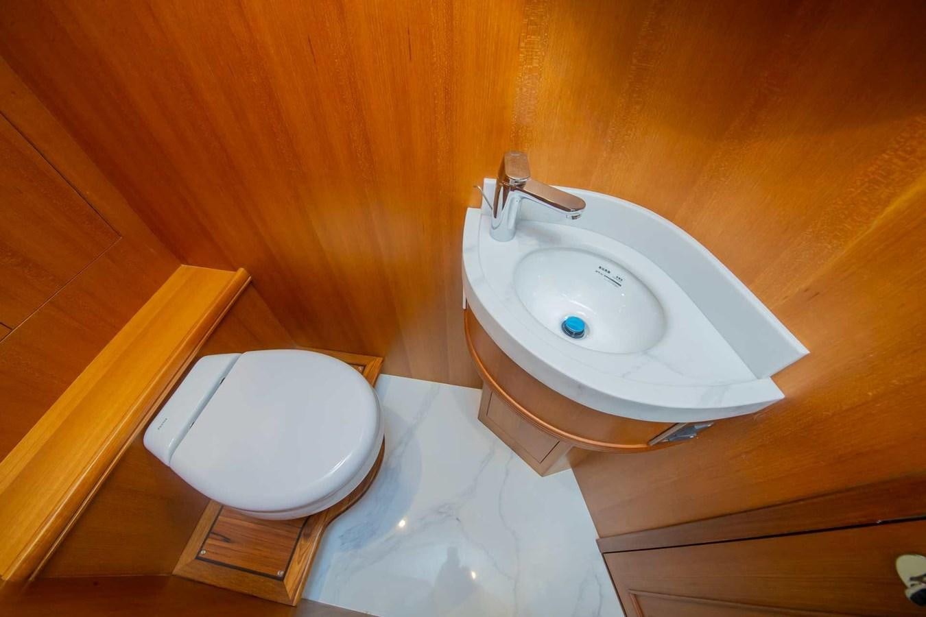 a toilet and a sink in a wooden room aboard 2024 SELENE 62 Yacht for Sale