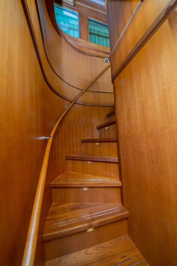 a wooden staircase with a spiral staircase aboard 2024 SELENE 62 Yacht for Sale