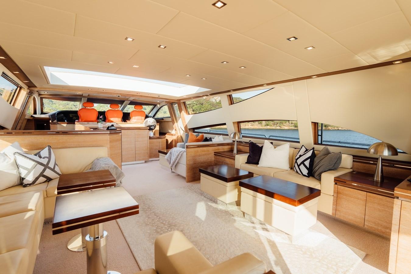 a room with a couch and a table aboard YOLO Yacht for Sale