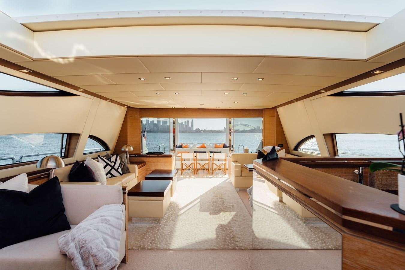 a room with a couch and a piano aboard YOLO Yacht for Sale