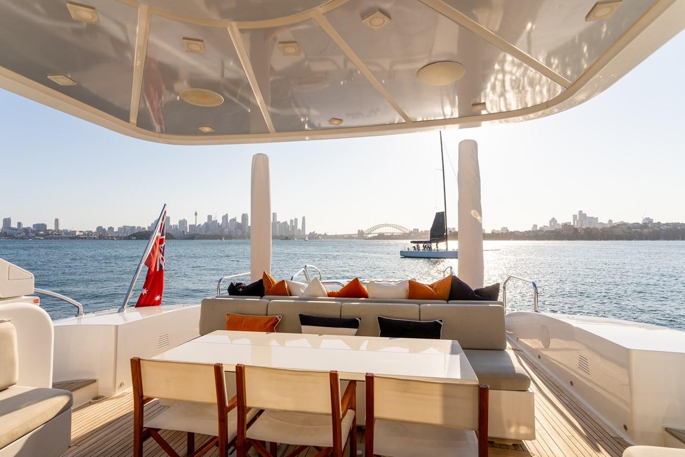 a boat with a table and chairs on it aboard YOLO Yacht for Sale