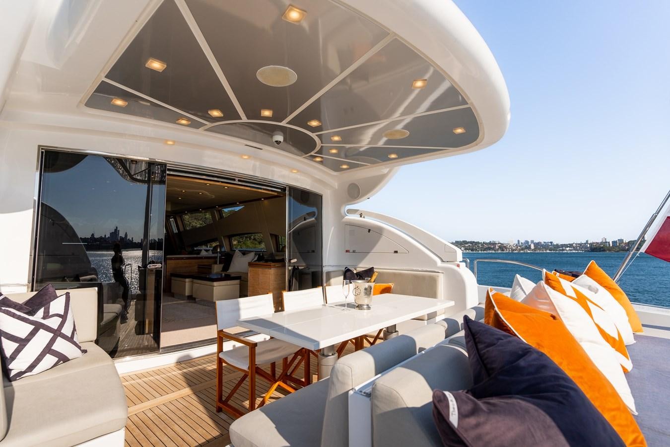 a boat with a table and chairs aboard YOLO Yacht for Sale