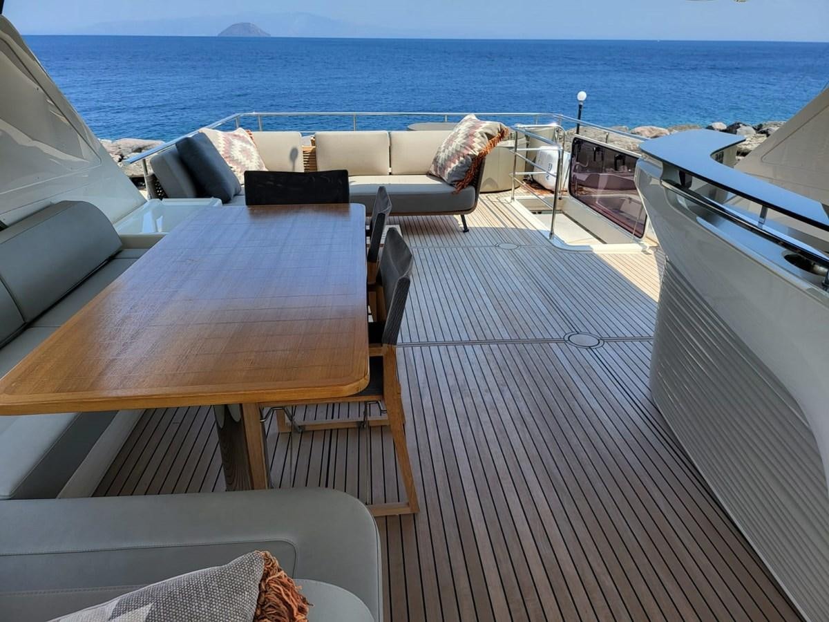 a deck with a table and chairs on it aboard ELYSIUM Yacht for Sale