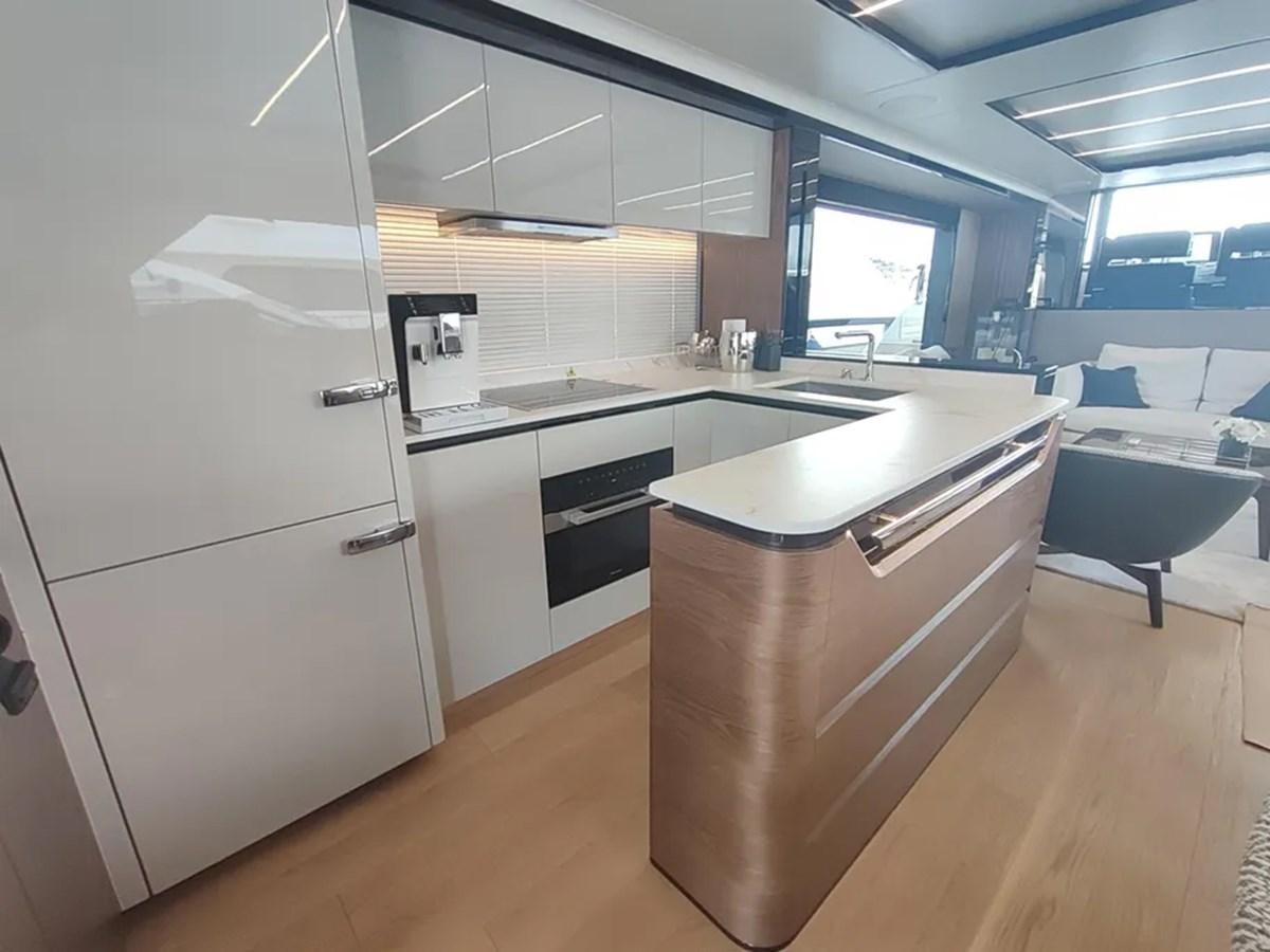 a kitchen with a refrigerator and a stove aboard ELYSIUM Yacht for Sale