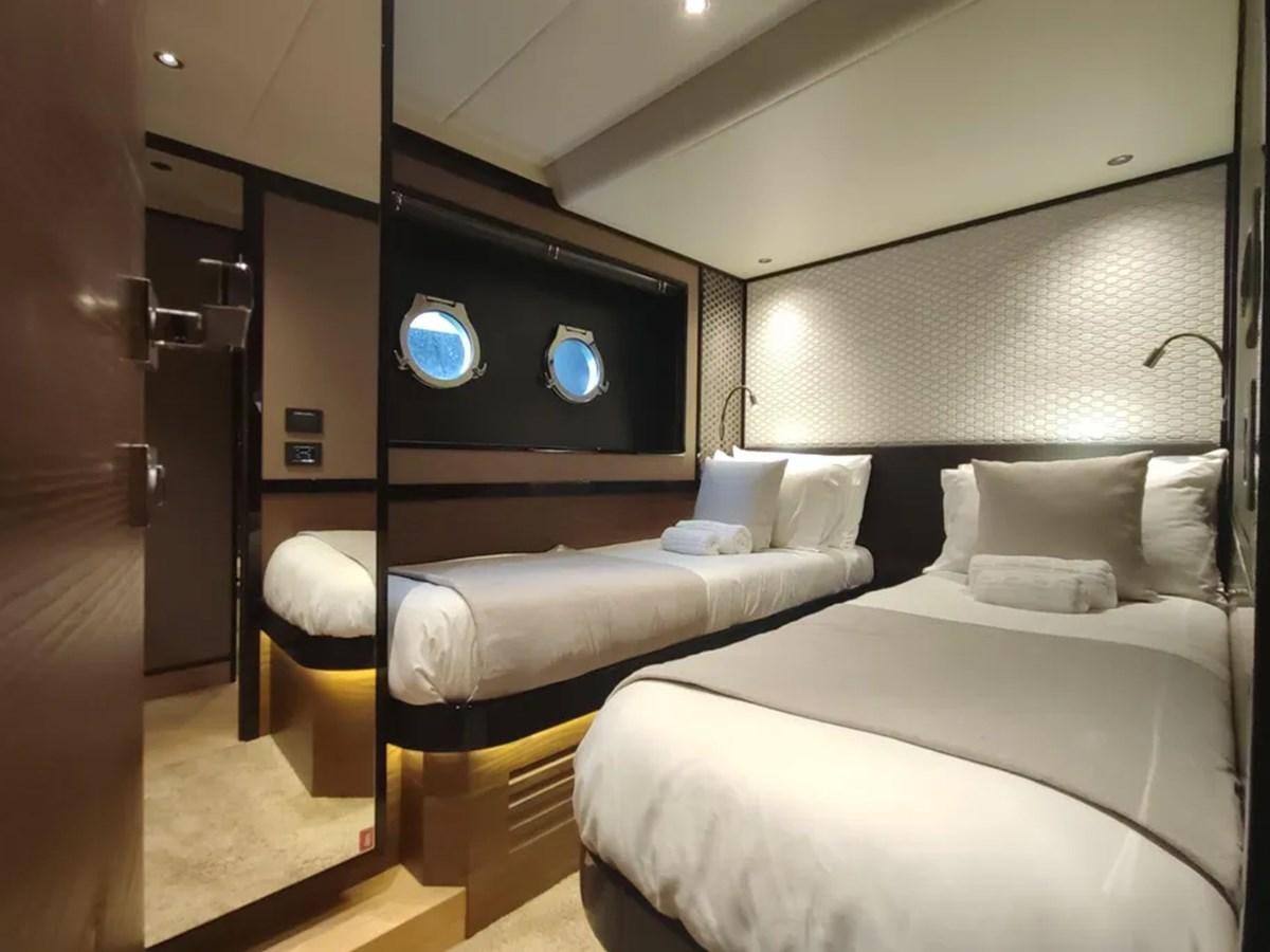 a room with a bed and a tv aboard ELYSIUM Yacht for Sale