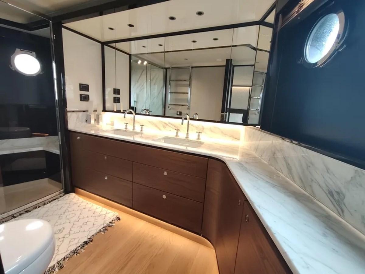 a bathroom with a large mirror aboard ELYSIUM Yacht for Sale