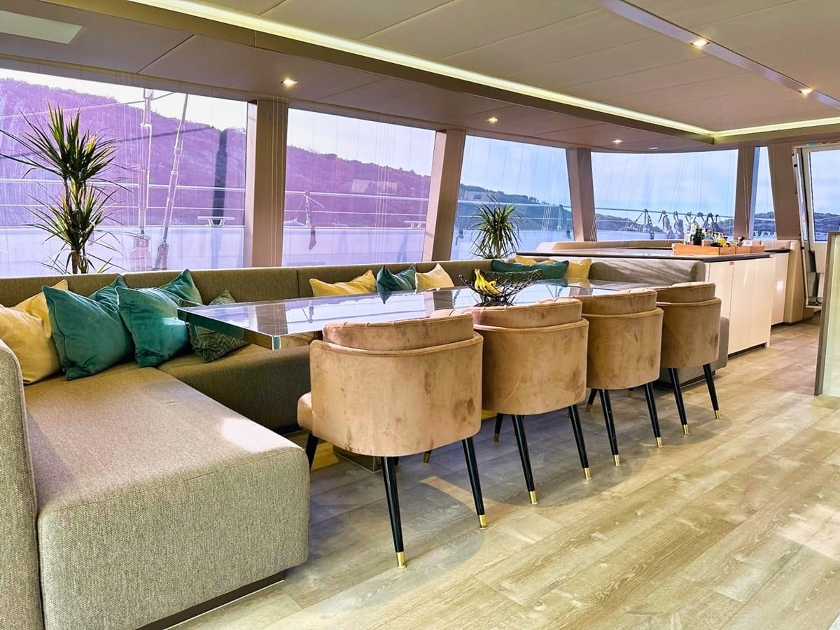 a room with couches and chairs aboard NALA ONE Yacht for Sale