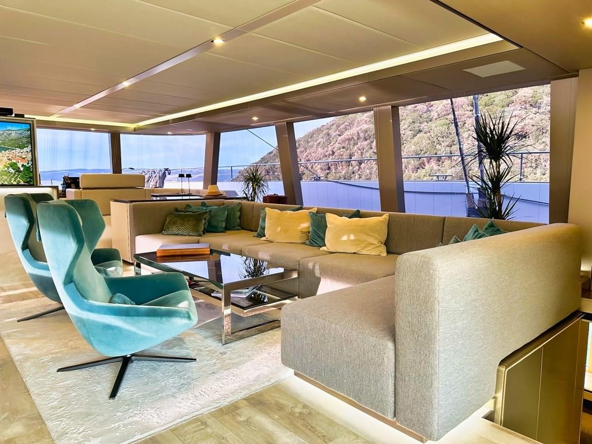 a living room with couches and a table aboard NALA ONE Yacht for Sale