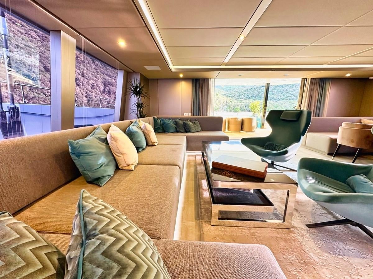 a living room with a large window aboard NALA ONE Yacht for Sale