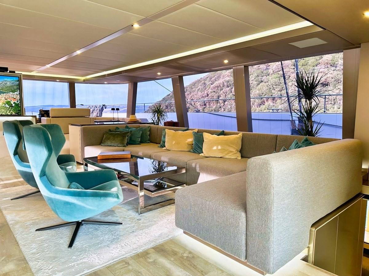 a room with couches and a table aboard NALA ONE Yacht for Sale