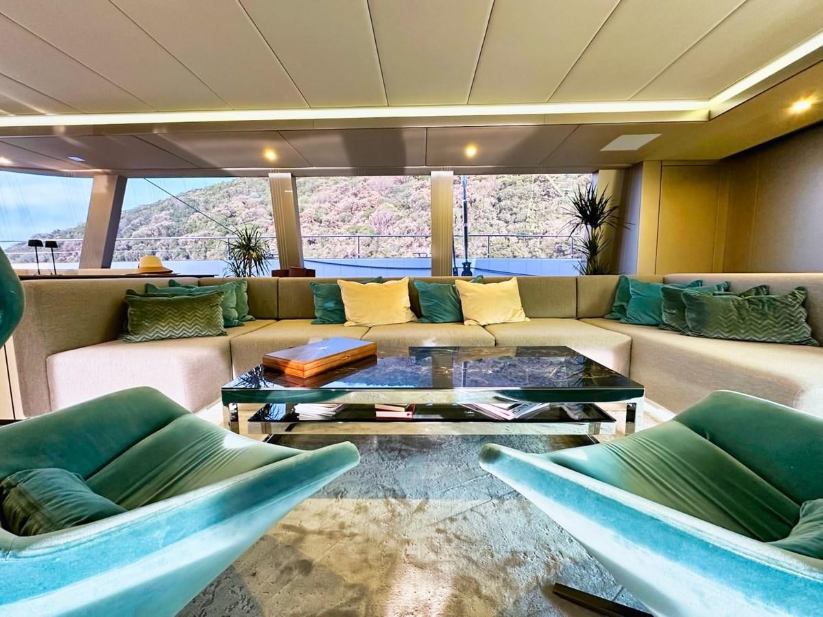 a living room with a large glass window aboard NALA ONE Yacht for Sale