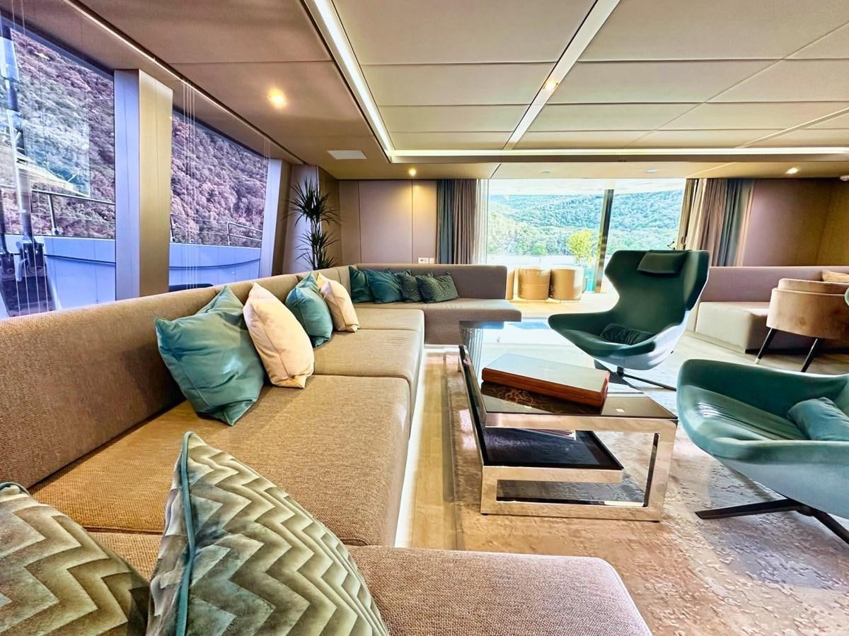 a living room with a large window aboard NALA ONE Yacht for Sale