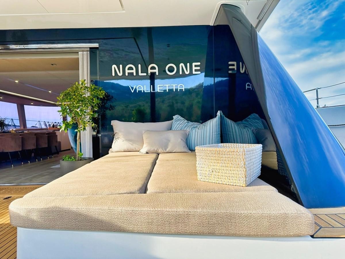 a bed with pillows aboard NALA ONE Yacht for Sale