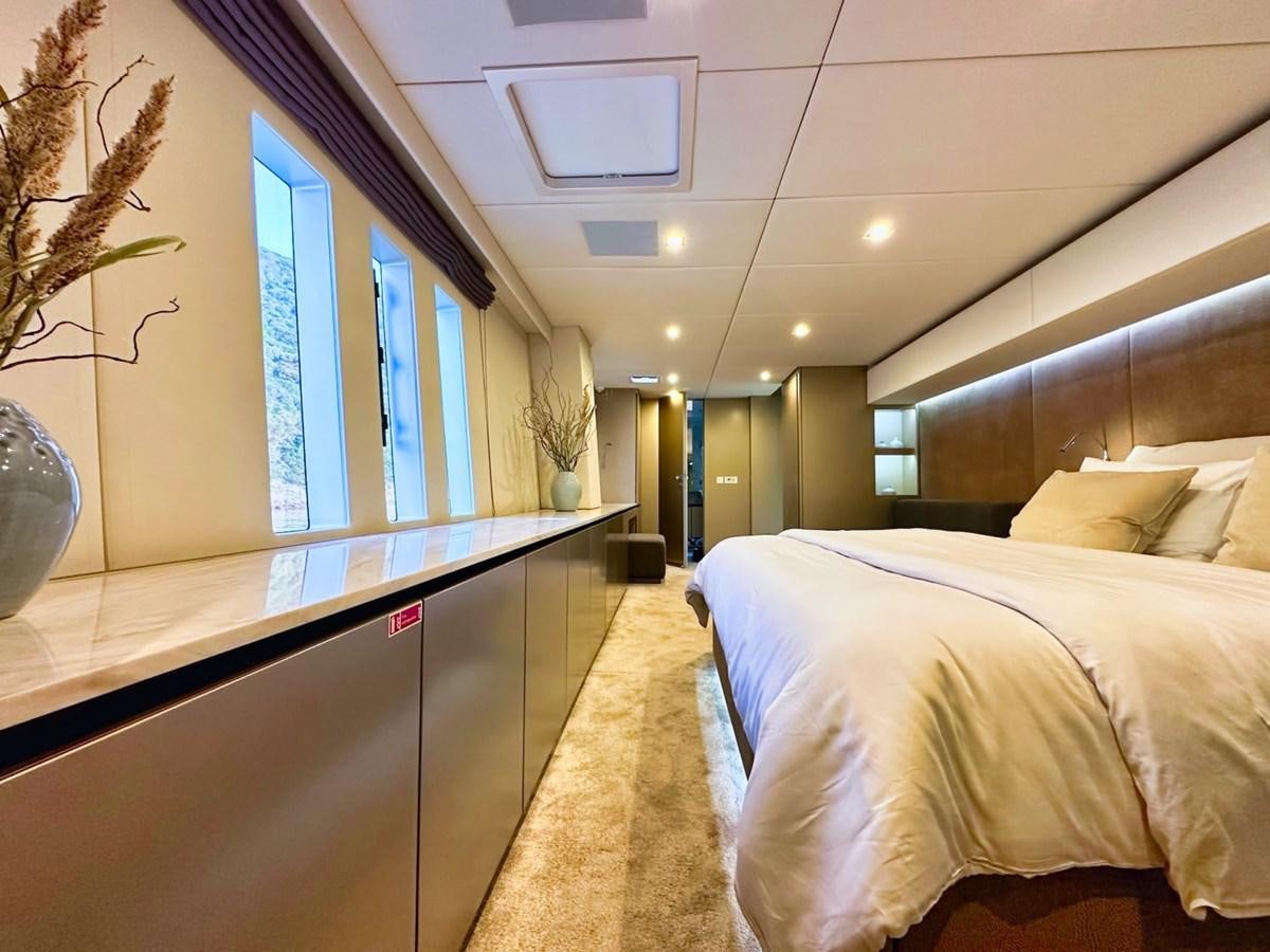 a room with a bed and a window aboard NALA ONE Yacht for Sale