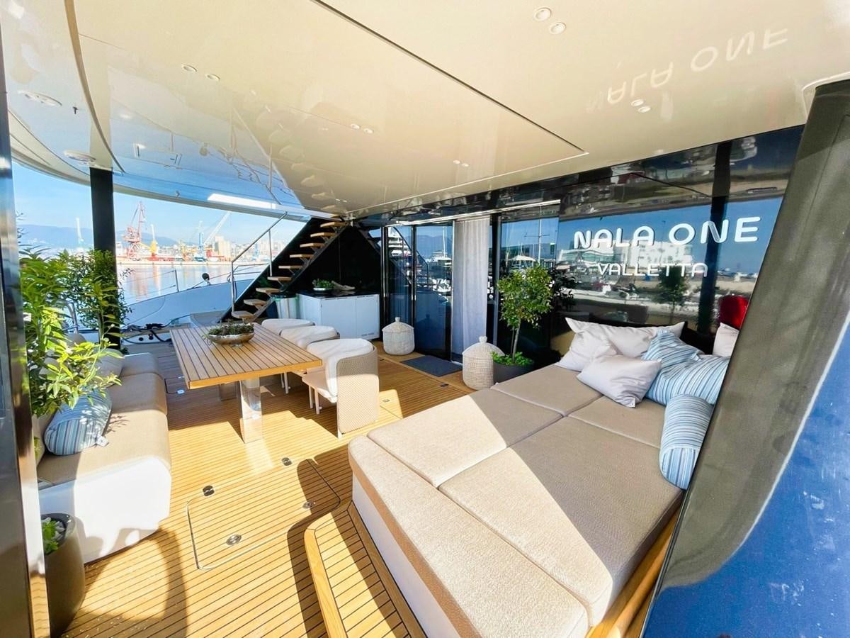 a room with a bed and a table aboard NALA ONE Yacht for Sale
