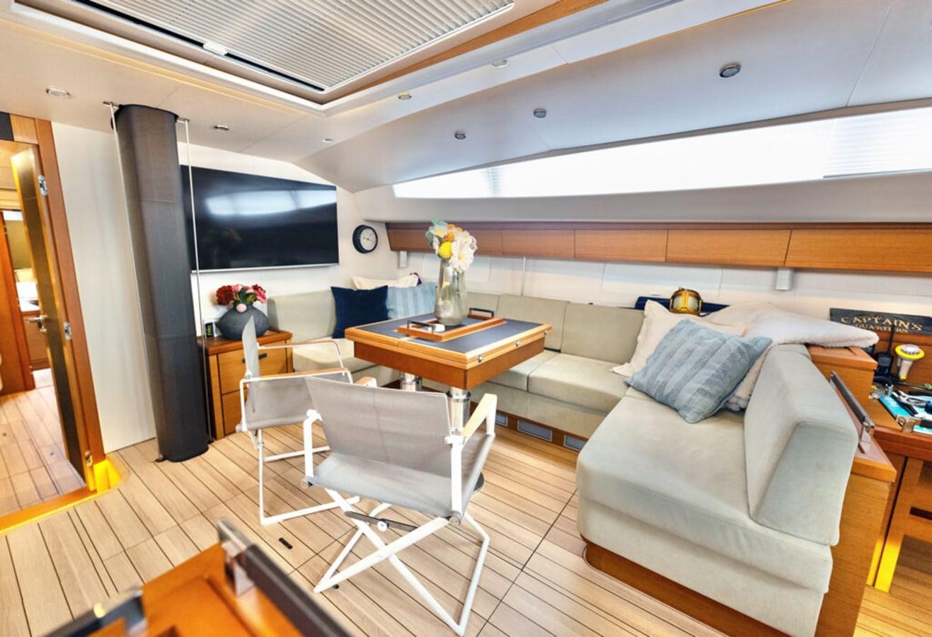 a living room with a couch and a table aboard 2021 JEANNEAU 64 – “MAH NA MAH NA” Yacht for Sale