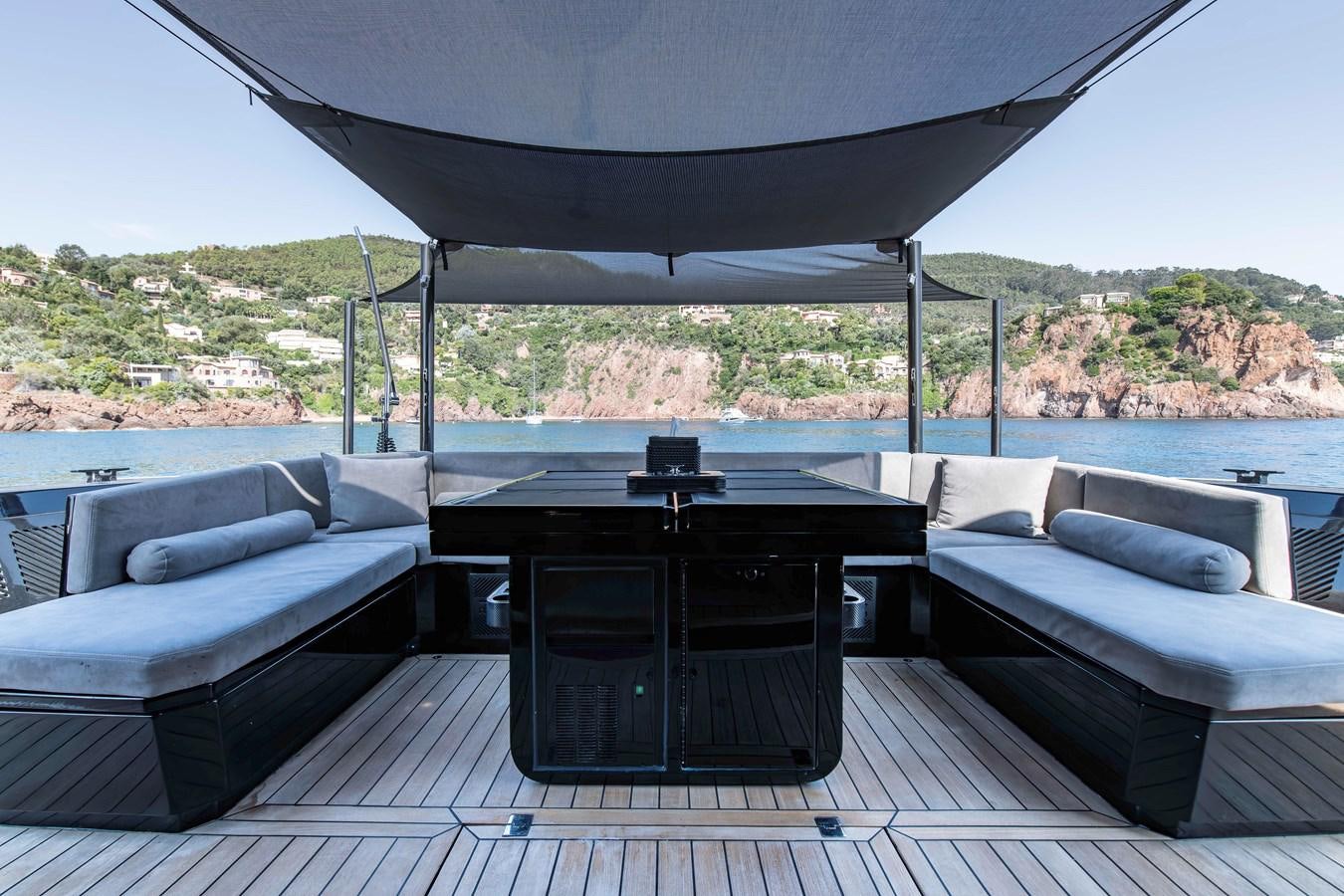 a large patio with a table and a couch aboard MATARIKI Yacht for Sale