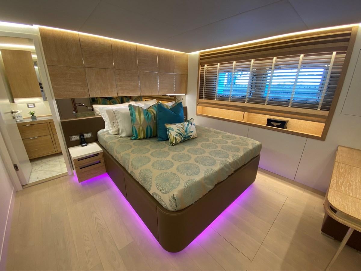 a bedroom with a bed and a window aboard CALLIOPE Yacht for Sale