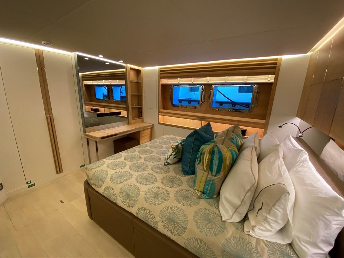 a bed with pillows and a television aboard CALLIOPE Yacht for Sale