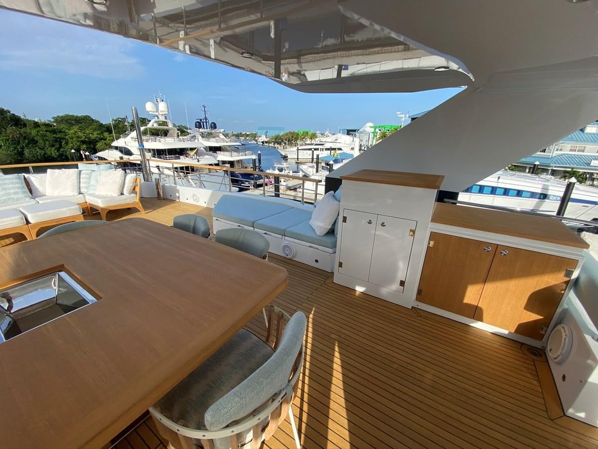 a deck with a table and chairs on it aboard CALLIOPE Yacht for Sale