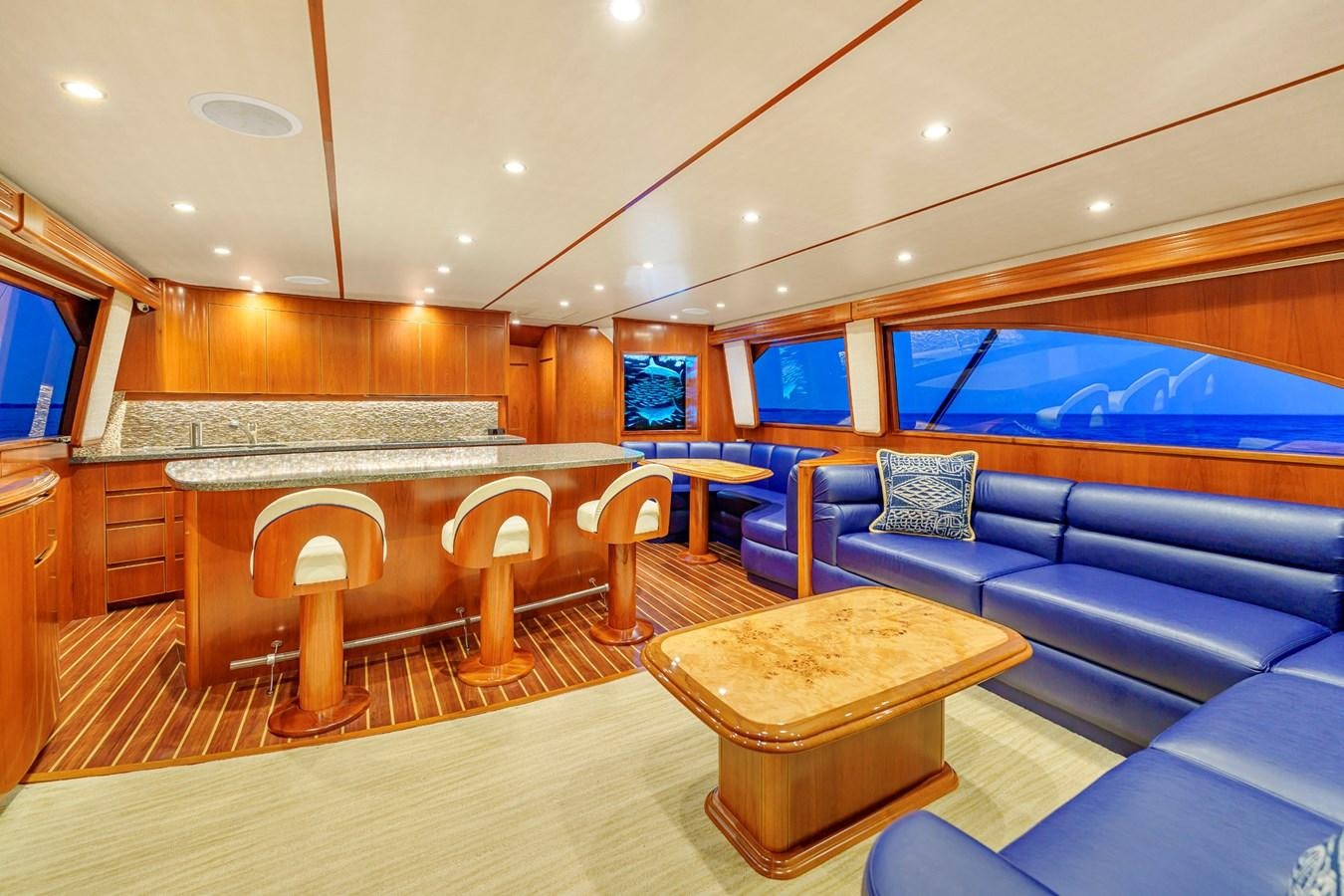 a living room with a blue couch aboard LIFE IS GOOD Yacht for Sale