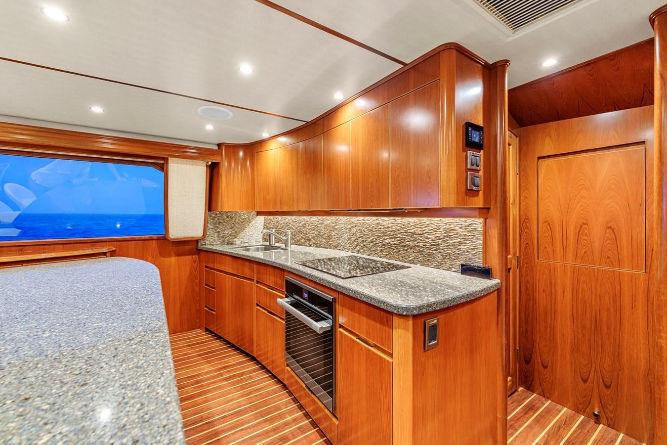 a kitchen with wooden cabinets aboard LIFE IS GOOD Yacht for Sale