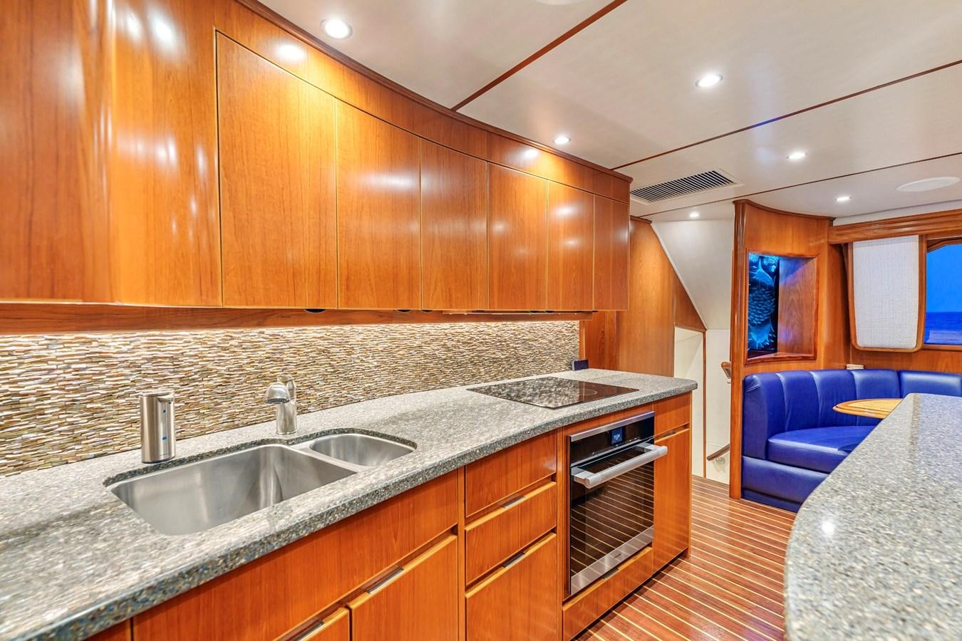 a kitchen with wooden cabinets aboard LIFE IS GOOD Yacht for Sale