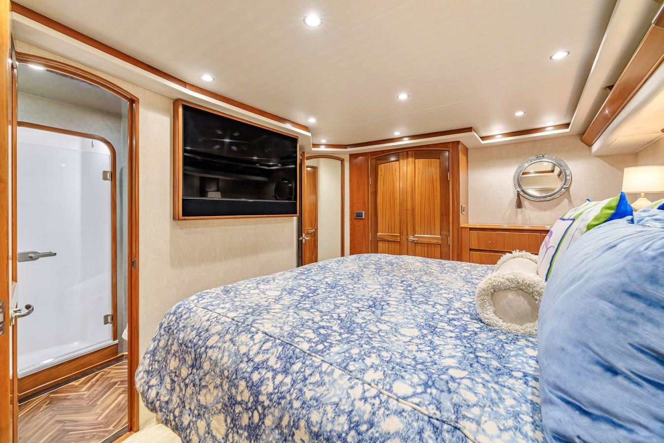 a bedroom with a bed and television aboard LIFE IS GOOD Yacht for Sale