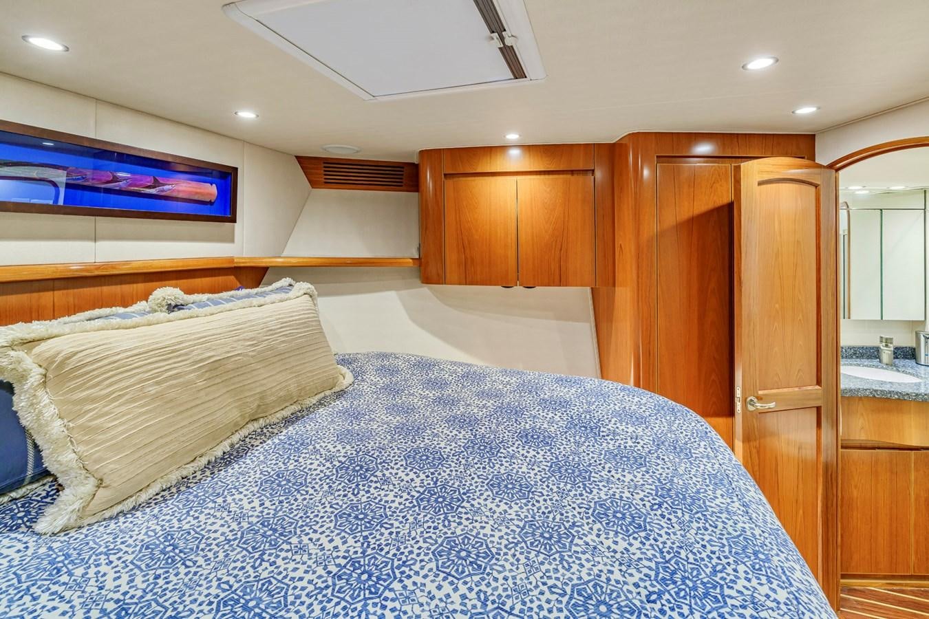 a bed with a white bed spread aboard LIFE IS GOOD Yacht for Sale
