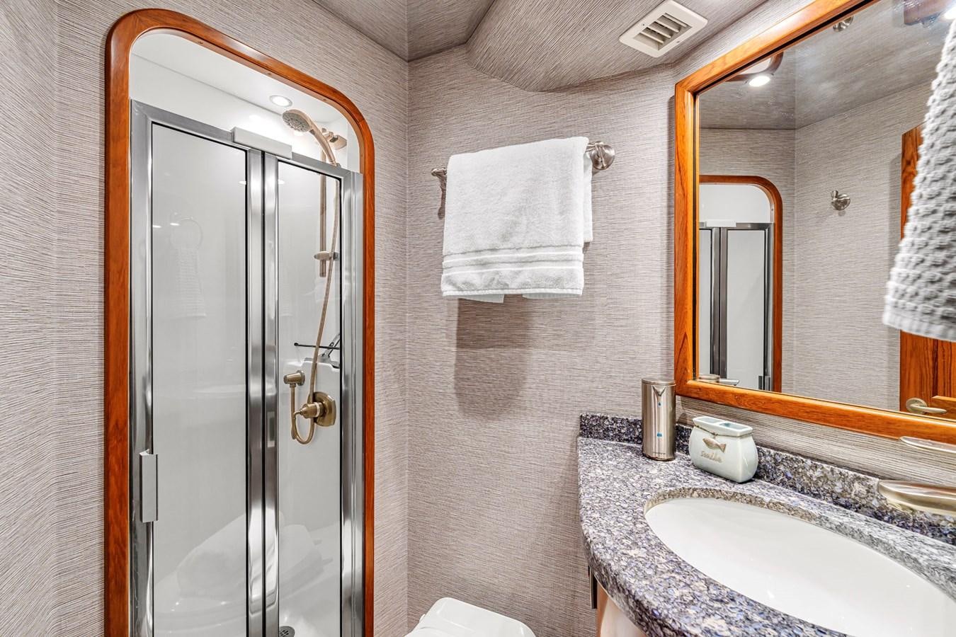 a bathroom with a shower and sink aboard LIFE IS GOOD Yacht for Sale
