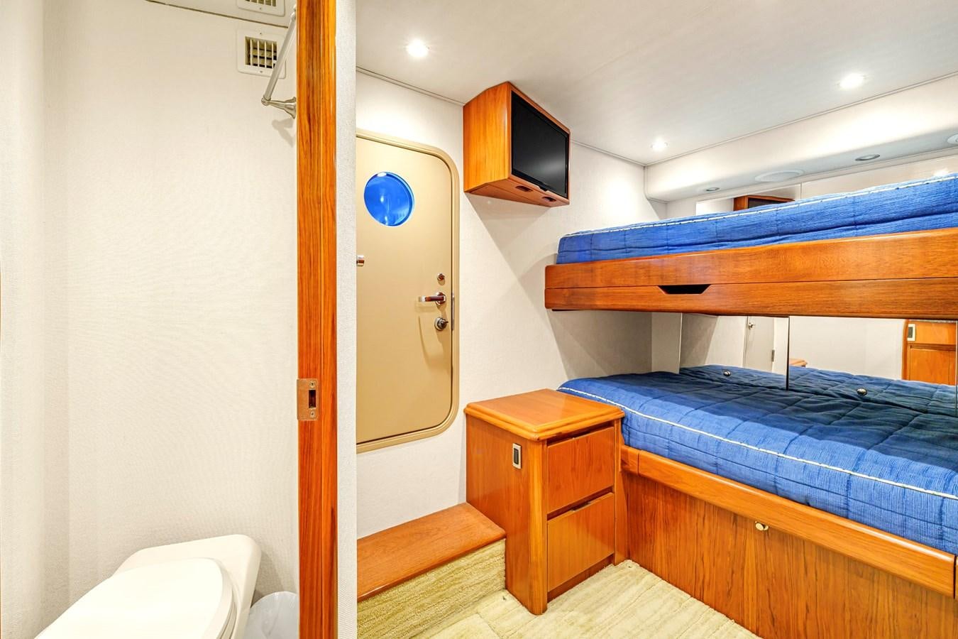a room with a bed and a television aboard LIFE IS GOOD Yacht for Sale