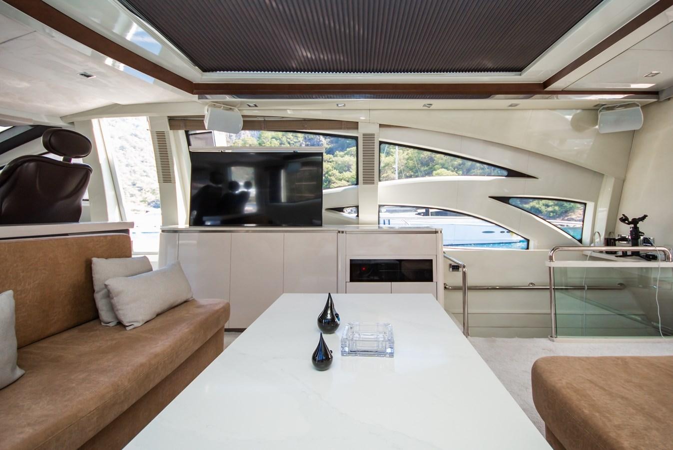 a living room with a large white table and a large television aboard AZIMUT 86S Yacht for Sale
